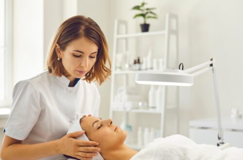 Esthetician working with a client. Esthetician schools.