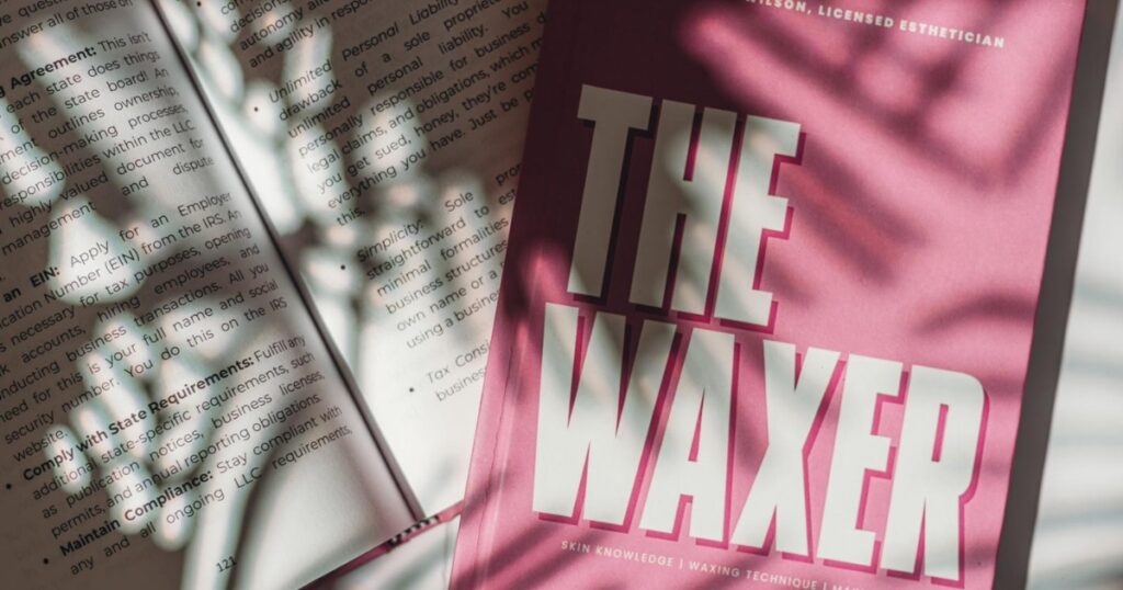 Book with a pink cover with the title The Waxer.